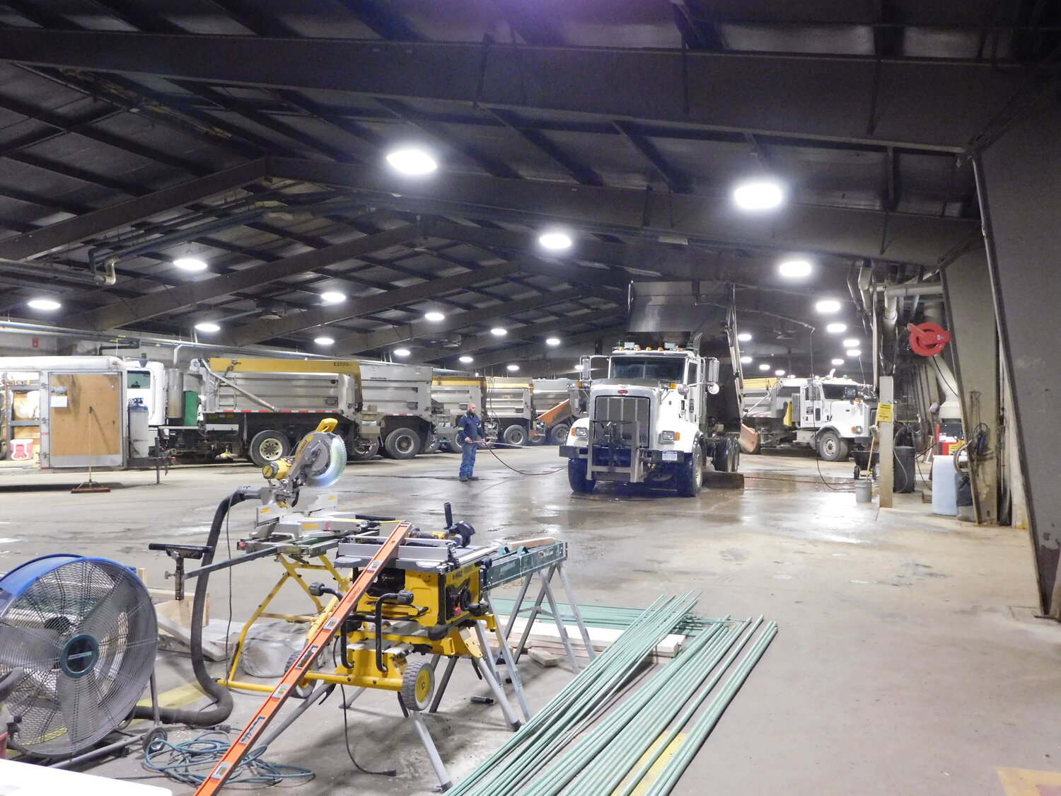 This photo shows the expansiveness of the garage which houses the CCRC trucks. At the bottom is the chop saw and reinforcing rod used in production of the precast bridge deck panels.